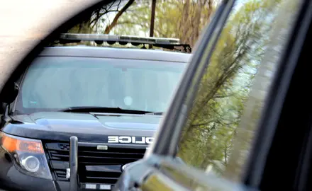 An image of a police SUV in another car's side mirror.