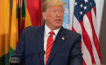 Donald Trump stands at a podium