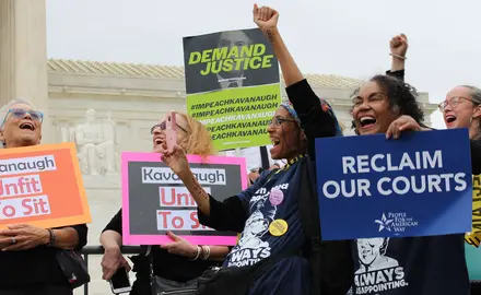 Activists hold signs outside the Supreme Court saying "Kavanaugh: Unfit to Sit," "Reclaim our courts," and "Demand justice: Impeach Kavanaugh"