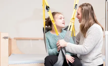 A child with disabilities and her caregiver