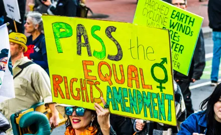 Participant of the 2020 Women's March - San Francisco holds a sign reading "Pass the Equal Rights Amendment!"