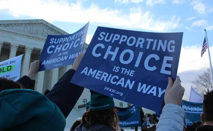 Activists hold signs that say "Supporting Choice is the American Way" at the #MyRightMyDecision rally at the Supreme Court