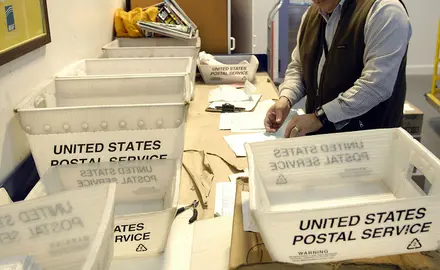 United States Postal Service boxes on table.