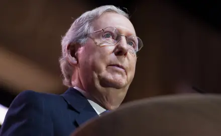 Mitch McConnell stands at a podium.