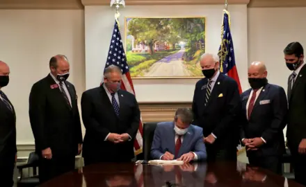 GA Governor Brian Kemp signing voter suppression bill SB202 into law on March 25, 2021