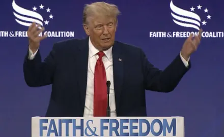 Donald Trump at a podium that reads "Faith and Freedom"