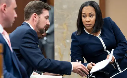 Fulton County District Attorney Fani Willis, right, talks with a member of her team during proceedings to seat a special purpose grand jury in Fulton County, Georgia, on May 2, 2022, to look into the actions of former President Donald Trump and his supporters who tried to overturn the results of the 2020 election. (AP Photo/Ben Gray, File)