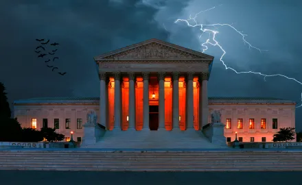 A scary image of the Supreme Court building with orange lights, lightning, and bats