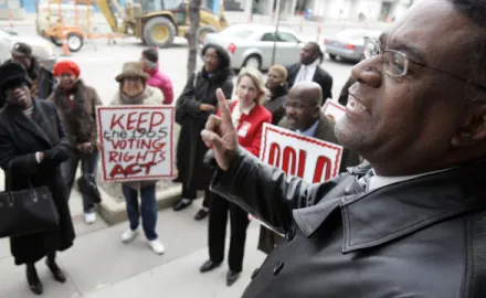 Dr. Tony Minor, right, speaks before a march Tuesday, April 4, 2006 in Cleveland. (AP Photo/Tony Dejak)