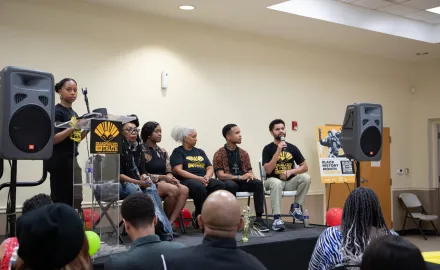 4 panelists on a stage at a Black History Month event.