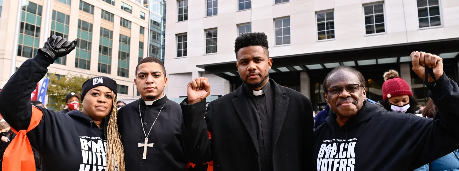 Black members of the clergy at a protest