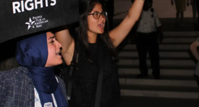 Two women hold signs saying "Save SCOTUS" and "Save workers' rights" outside the Supreme Court with the title Confirmed Judges, Confirmed Fears