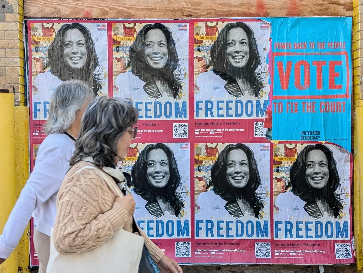 "Kamala Harris: Freedom" posted with people walking by