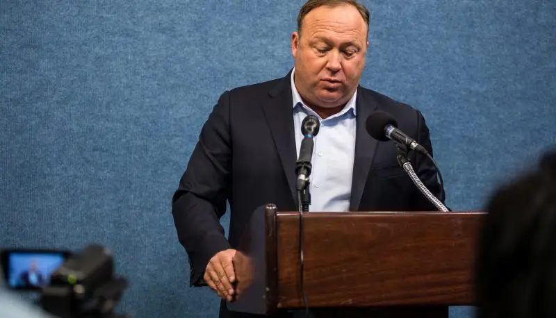 Infowars host Alex Jones reads from a legal brief at the National Press Club in Washington, D.C., on April 10, 2018.