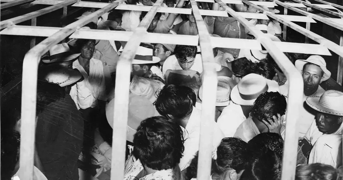 Mexican immigrants caged and packed into the back of a truck for transport to the border for deportation