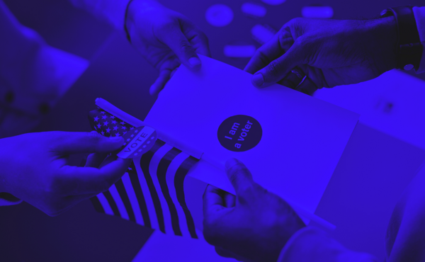 A blue image of a man holding a piece of paper that says I am a voter