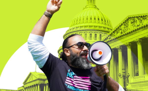 Man with a megaphone in front of a stylized picture of the U.S. Capitol