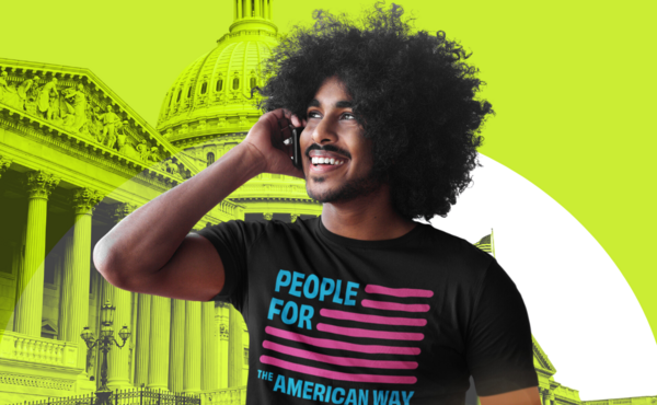 Black man in front of the U.S. Capitol making a phone call