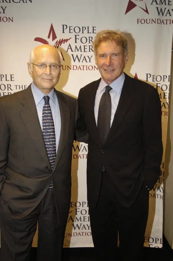 Norman Lear with Harrison Ford in front of a People For the American Way poster