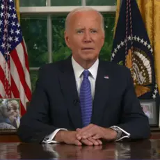 President Joe Biden sitting at his desk in the Oval Office.