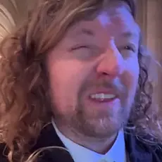 Sean Feucht with face in a grimace from within Washington National Cathedral