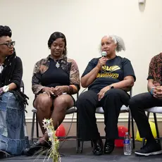 Speakers gather on stage to discuss the importance of teaching Black history