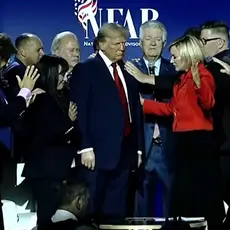 A group of religious-right leaders lay hands on Trump and pray for him at a "national faith summit" sponsored by Paula White's National Faith Advisory Board. 