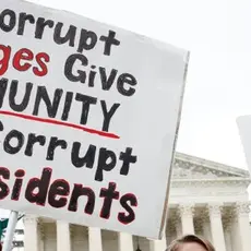 Protestors at the Supreme Court hold signs that read "No one is above the law."