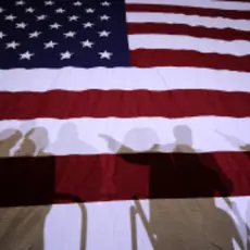 Flag with shadows of people in front of it.