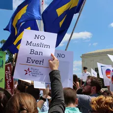 Woman holding "no muslim ban ever!" sign at rally