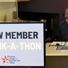 A Sign that says "PFAW Member Thank-a-Thon" in front of a PFAW staff member's desk