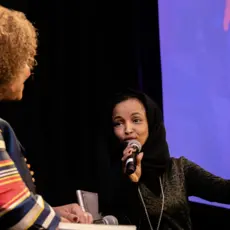 Two women speak at the YEO Women's Conference