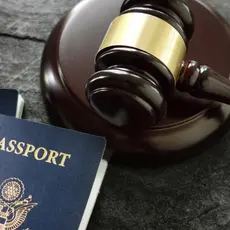 A gavel sits next to two American passports