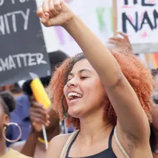 A group of Black women holding signs in favor of Black Lives Matter