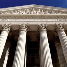 An image of the facade of the Supreme Court Building taken from below.