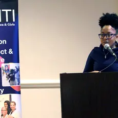 Lauren Wilson speaks from behind a podium at the 2019 spring VASHTI Convocation