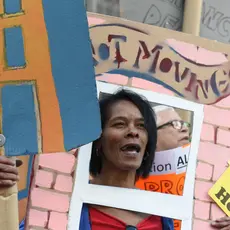 Activists march across the Brooklyn Bridge holding signs demanding affordable housing.