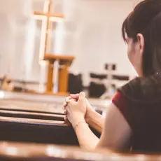 A woman prays in a church