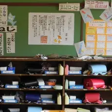 photo of a set of cubbies and posters hanging on the wall above them