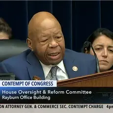 Elijah Cummings sits behind a podium during a committee meeting.