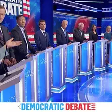 Candidates stand behind podiums on stage at a Democratic debate