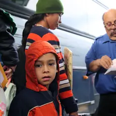 A young Central American boy who entered the U.S. illegally boards a bus with his mother to go to their sponsor where they'll wait for an asylum hearing.