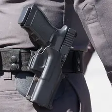 Close up of the gun on a police officer's belt