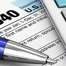 picture of tax form with pen and calculator