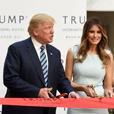 Donald Trump with his wife and children cutting the ribbon on Trump hotel.