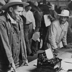 Mexican farm workers line up as they are registered to work in the US through the Bracero program.