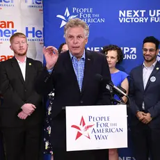 Former VA Gov. Terry McAuliffe at the speaker's podium at PFAW's Next Up 2019 Virginia kickoff event.