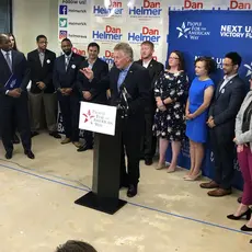 Former VA Gov. Terry McAuliffe at the speaker's podium at PFAW's Next Up 2019 Virginia kickoff event.