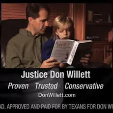 A screenshot from Don Willett's 2012 campaign ad that shows him reading the Bible with a child.