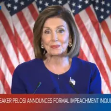 A screenshot of CBS News showing Nancy Pelosi standing in front of a line of American flags with the text "Speaker Pelosi announces formal impeachment inquiry."